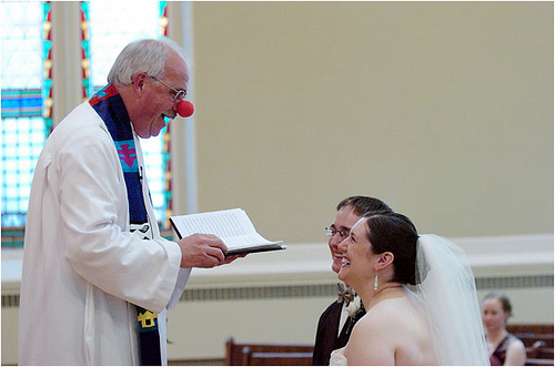 Clown pretending to marry a couple.