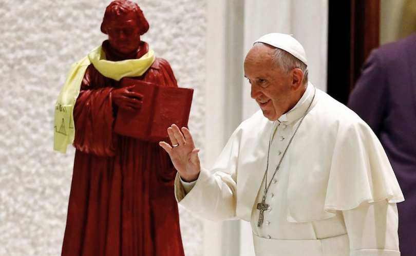 Jorge Mario Bergoglio in front of a statue of Luther in the Vatican.